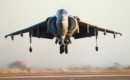 An AV 8B Harrier hovers over the flight line of Marine Corps Air Station.