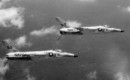 Two U.S. Navy Grumman F11F 1 Tiger fighters of Fighter Squadron VF 33 Astronauts in flight in 1960.